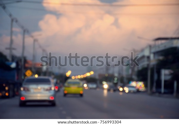 Blurred image of\
lanterns traffic lighting and car lighting on the road in evening\
time abstract bokeh\
background