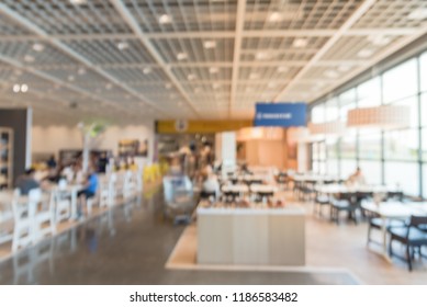 Blurred Image Large Cafeteria, Canteen, Food Court At Shopping Mall Or Corporate In Texas, USA. Defocused Modern Public Dining Area Natural Lights From Windows For Background Use, Customer Eating