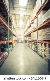 Blurred image large warehouse with row of aisles and shelves from floor to ceiling with bin number. Defocused background of industrial distribution storehouse interior wholesale. Vintage filter.