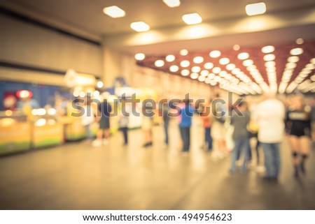 Blurred image a long queue of people waiting for popcorn from wagon vendor in Dallas, Texas, US. Vintage filter look.