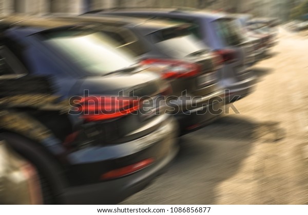 blurred image of luxury\
modern Cars For Sale Stock Lot Row. Car Dealer Inventory. Cars For\
Sale Stock Lot Row. Car Dealer Inventory. sunset sun rays light.\
sun beam