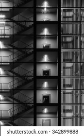 Blurred image of modern building exterior. Staircase, lift and stairwell through transparent glass. Black and white concept