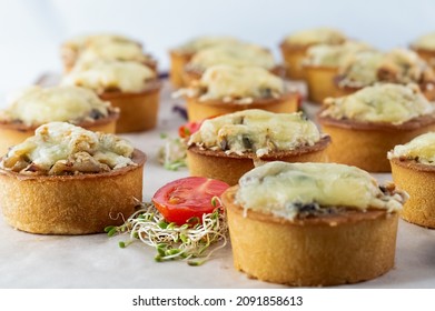 Blurred image of mushroom cheese tartlets on a plate with micro greens and cherry tomatoes. - Shutterstock ID 2091858613
