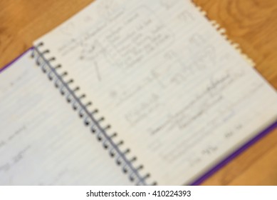 Blurred image of notebook with text