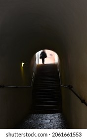 Blurred Image. An Old Abandoned Haunted House. Interior With Stairs Leading Up. Black Silhouette Of A Girl On A Background Of A Window. Halloween Horror Concept.