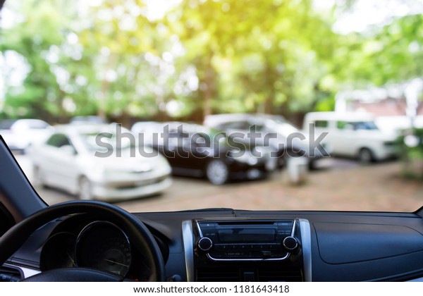 blurred image of the outdoor car park look from\
inside the car