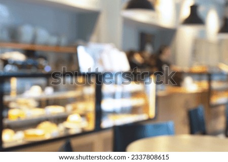 Blurred image of pastry shop interior background. Defocused view of a showcase with confectionery. Bokeh lighting.