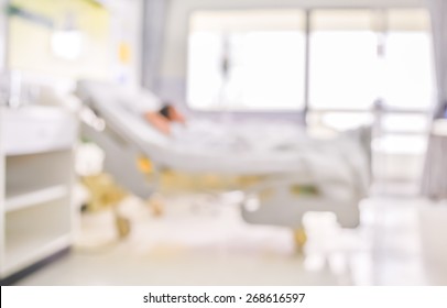 Blurred Image Of Patient With Drip In Hospital For Background Usage.