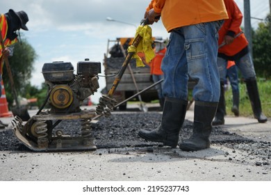 Blurred Image Of Pavement Repair Work. It's A Low Angle Photo.