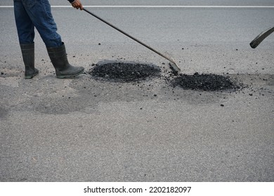 Blurred Image Of Pavement Repair Work. It's A Low Angle Photo.