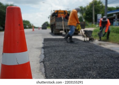 Blurred Image Of Pavement Repair Work. It's A Low Angle Photo.