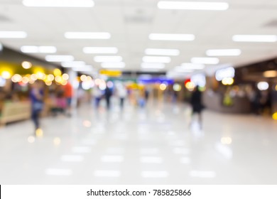 blurred image of people in the airport terminal with beautiful bokeh from the light