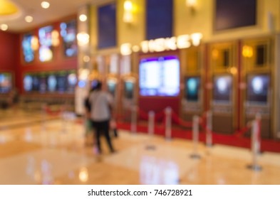 Blurred Image Of People Buy Cinema Tickets From Automatic Ticket Machine At Movie Theater