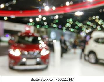 Blurred image of people in cars exhibition show