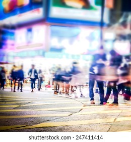 Blurred Image Of People Moving In Crowded Night City Street With Sopping Malls. Hong Kong. Blur Effect