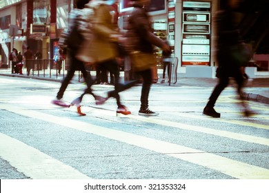 Blurred Image Of People Moving In Crowded City Street. Art Toning Abstract Urban Background. Hong Kong