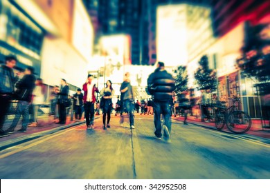 Blurred Image Of People Moving In Crowded Night City Street. Art Toning Abstract Urban Background. Hong Kong