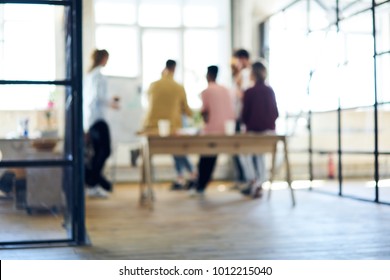 Blurred image, people silhouette collaborating in office interior. Defocused space for your information, teamwork process. Group of coworkers discussing ideas. Colleagues having informal work meeting - Powered by Shutterstock