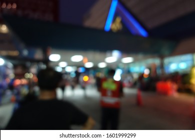 Blurred Image Of People Wait For Bus Inside Bus Terminal For Long Holiday, New Year Festival In Night Time For Come Back To See Their Family. They Carry Passenger's Goods And Luggage.