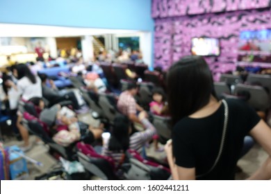 Blurred Image Of People Wait For Bus Inside Bus Terminal For Long Holiday, New Year Festival In Night Time For Come Back To See Their Family. They Carry Passenger's Goods And Luggage.