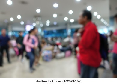 Blurred Image Of People Wait For Bus Inside Bus Terminal For Long Holiday, New Year Festival In Night Time For Come Back To See Their Family. They Carry Passenger's Goods And Luggage.