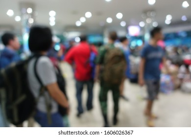 Blurred Image Of People Wait For Bus Inside Bus Terminal For Long Holiday, New Year Festival In Night Time For Come Back To See Their Family. They Carry Passenger's Goods And Luggage.