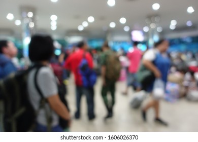 Blurred Image Of People Wait For Bus Inside Bus Terminal For Long Holiday, New Year Festival In Night Time For Come Back To See Their Family. They Carry Passenger's Goods And Luggage.