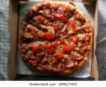 A blurred image of a pepperoni pizza - Shutterstock ID 1898177692