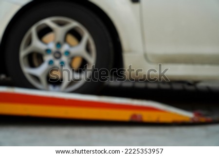 Blurred image personal slides onto a tow truck for emergency transport.
