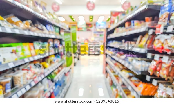 Blurred\
image of product shelves in convenience\
stores.