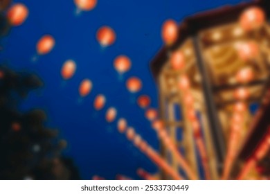 Blurred image of red lanterns glowing at night. Lanterns illuminate the sky, creating a festive atmosphere. Red lanterns symbolize celebration and joy. China town lanterns image. - Powered by Shutterstock