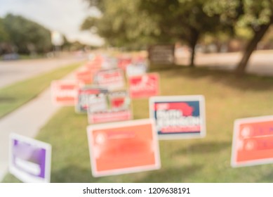 Blurred Image Row Of Yard Sign At Residential Street For Primary Election Day In Dallas County, Texas, USA. Signs Greeting Early Voters, Political Party Posters For The Midterm Election Concept