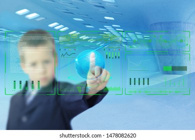 blurred image of a schoolboy performing a task on a technological display, selective sharpness in the foreground, the concept of a virtual school of the future