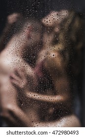 Blurred image of a sexy couple embracing under shower