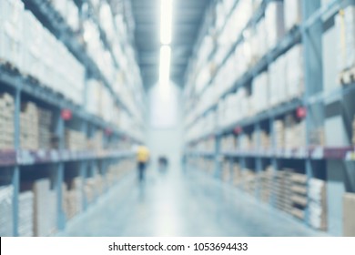 Blurred Image Of Shelf In Modern Distribution Warehouse Or Storehouse. Defocused Background Of Industrial Warehouse Interior Aisle