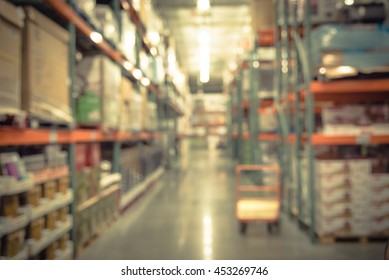 Blurred Image Of Shelf In Modern Distribution Warehouse Or Storehouse. Defocused Background Of Industrial Warehouse Interior Aisle. Inventory, Hypermarket,wholesale Concept, Bokeh Light.Vintage Filter