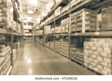 Blurred image of shelves in modern distribution warehouse or storehouse. Defocused background of industrial warehouse interior aisle. inventory, wholesale, logistic and export concept. Vintage filter. - Shutterstock ID 475248136