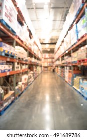 Blurred image of shelves in modern distribution warehouse or storehouse. Defocused background of industrial warehouse interior aisle. inventory, hypermarket, wholesale, logistic and export concept.