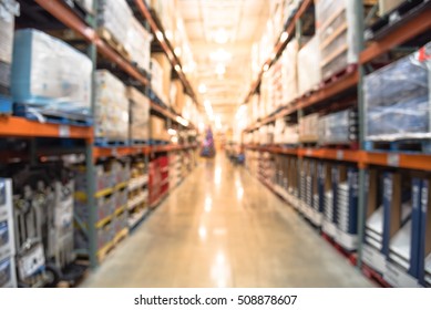 Blurred image of shelves in modern distribution warehouse or storehouse. Defocused background of industrial warehouse interior aisle. inventory, hypermarket, wholesale, logistic and export concept.