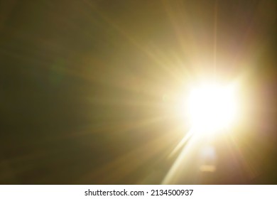 blurred image. shiny sun, sunbeams, sunrays, sunshine design. Yellow warm light effect, sun rays, golden beams isolated on black background. star dust