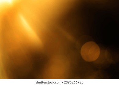 blurred image. shiny sun, sunbeams, sunrays, sunshine design. Yellow orange warm light effect, sun rays, golden beams isolated on black background. star dust - Shutterstock ID 2395266785