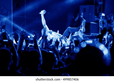 Blurred Image Of Singer On Top Crowd Surfing At A Music Concert