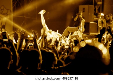 Blurred Image Of Singer On Top Crowd Surfing At A Music Concert