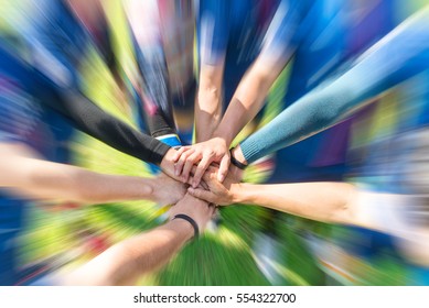 Blurred image of Soccer players putting their hands together Join team energy for power that makes winners - Shutterstock ID 554322700