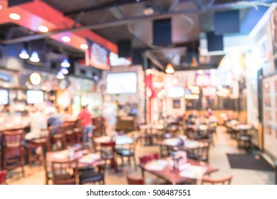 Blurred Image Sport And Gumbo, Oyster Bar With TV, Classic Counter, Tables And Chairs In Houston, Texas, US. Bar Happy Hour, Dine In Abstract Background With Bokeh Light. Night Club, Grill Bar Concept