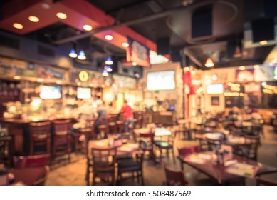 Blurred Image Sport And Gumbo, Oyster Bar With TV, Classic Counter, Tables And Chairs In Houston, Texas, US. Bar Happy Hour, Dine In Abstract Background. Night Club, Grill Bar Concept. Vintage Filter.