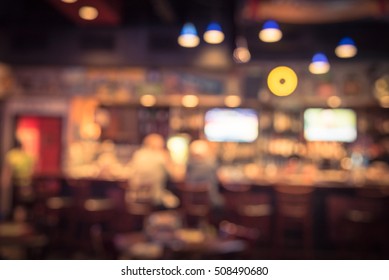 Blurred Image Sport And Gumbo, Oyster Bar With TV, Classic Counter, Tables And Chairs In Houston, Texas, US. Bar Happy Hour, Dine In Abstract Background. Night Club, Grill Bar Concept. Vintage Filter.