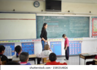 Blurred Image, Teacher Used The Stick To Hit The Elementary School Students In Front Of The Class