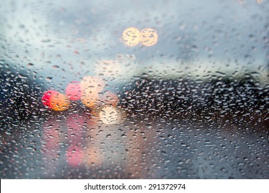 Blurred Image Of Traffic View Through A Car Windscreen Covered In Rain