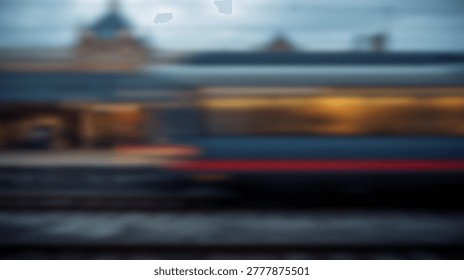 A blurred image of a train in motion, captured at dusk. The train streaks through the city, with lights creating a dynamic visual effect.